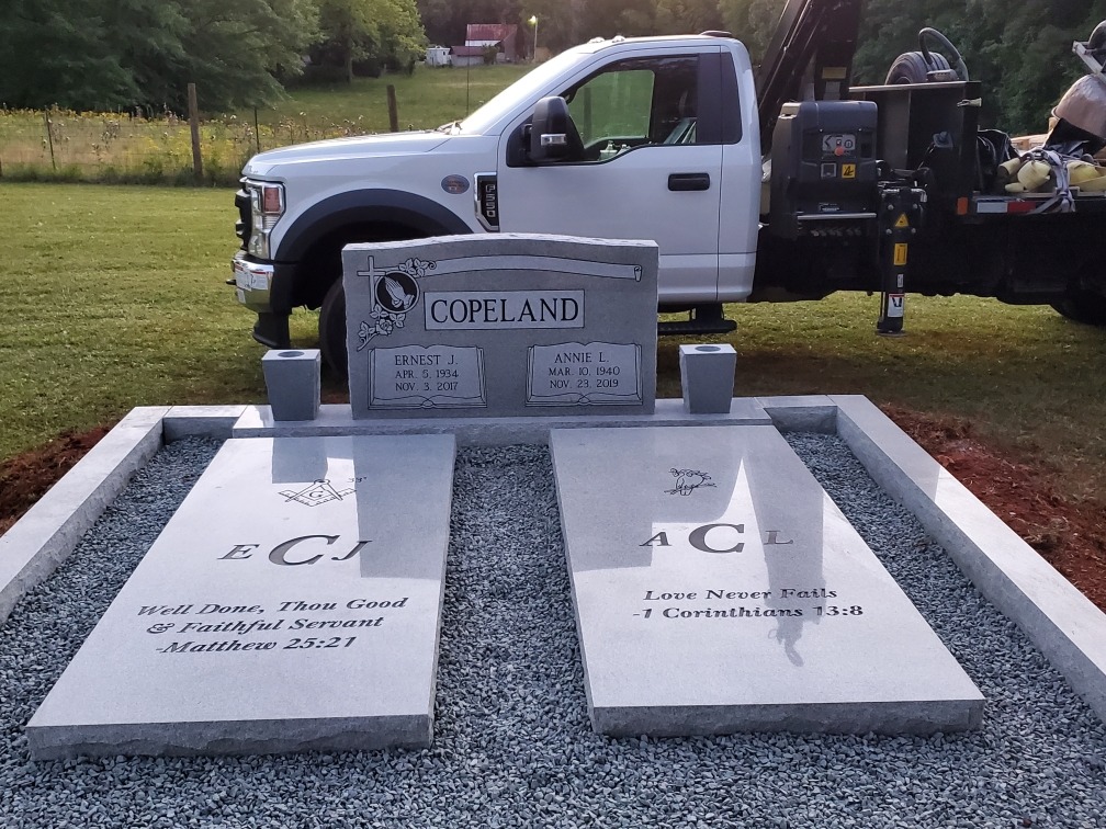 grey granite companion headstone with matching gravestones and coping wall