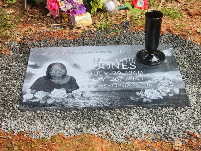 flat headstone with engraving and attached vase